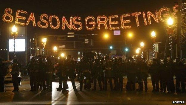 Police form a line in the street under a holiday sign after a grand jury returned no indictment in the shooting of Michael Brown in Ferguson, Missouri November 24, 2014.