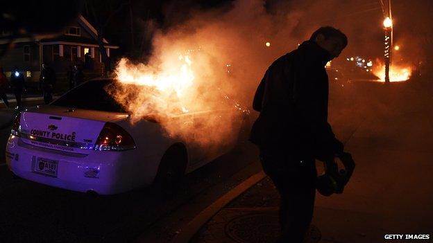 A police car burns in Ferguson, Missouri