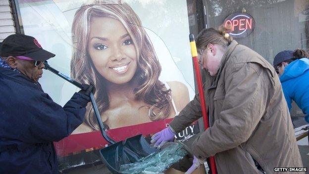 Volunteers help to clean up after violent protests damaged businesses following the grand jury announcement in the Michael Brown case Ferguson, Missouri 25 November 2014