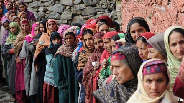 Kashmiri nomad voters queue outside a polling station in Babanagri on November 25, 201