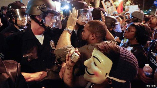 Protesters face off against a line of police in Los Angeles, California on 25 November 2014