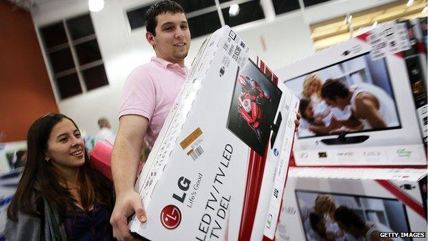 NOVEMBER 29: Black Friday shoppers carry away discounted items from at a Best Buy store which opened its doors at 6pm on Thanksgiving Day this year on November 29, 2013 in Naples, Florida. One of the busiest days in the calendar for retailers, over a dozen US stores opened their doors to shoppers one day ahead of the famed-Black Friday shopping day.