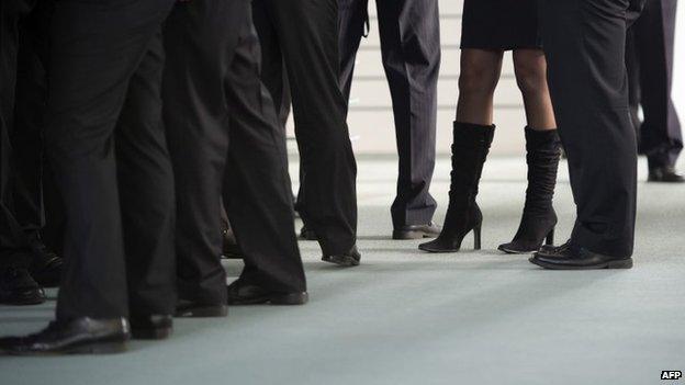 A woman stands surrounded by men at the chancellery in Berlin (9 November 2014)