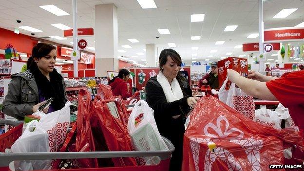 Christine Rocha and her cousin Melissa Menses gather their purchases at the check out stand during Black Friday sales at Target in the South Shore Plaza on November 23, 2012 in Braintree, Massachusetts. Black Friday, the start of the holiday shopping season, has traditionally been the busiest shopping day in the United States.