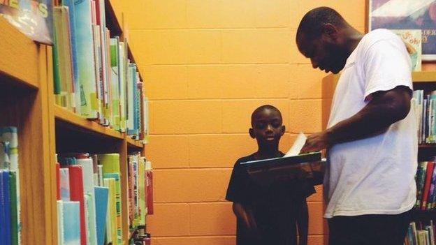 A father and son in a library