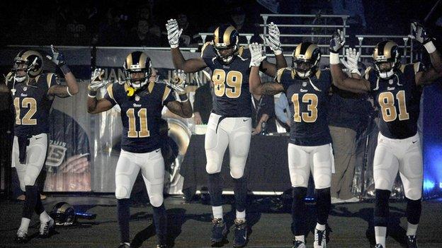 Five NFL players take the field in St Louis with a Ferguson protest gesture.