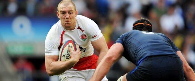 Mike Tindall takes on France's Jerome Thion