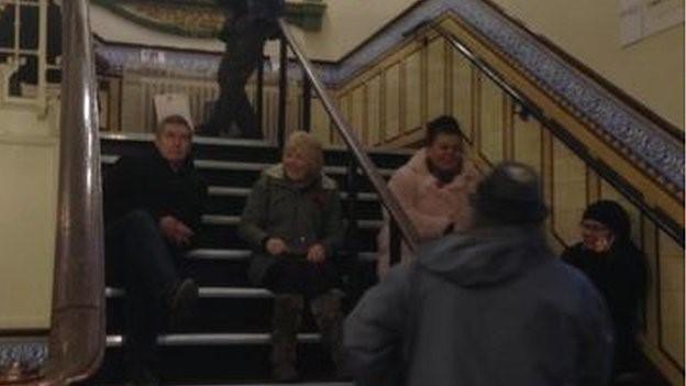 Campaigners sitting on some stairs