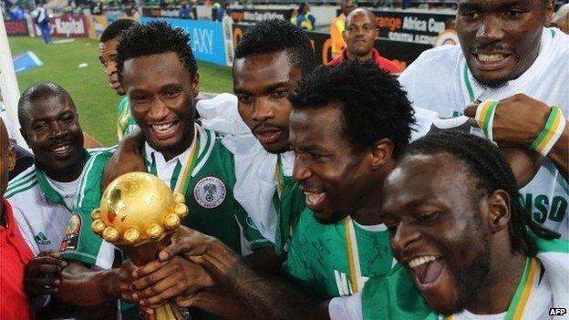 John Mikel Obi and Victor Moses lead celebrations with team mates with the trophy after winning the 2013 Africa Cup of Nations Final match between Nigeria and Burkina at FNB Stadium on 10 February 2013 in Johannesburg, South Africa