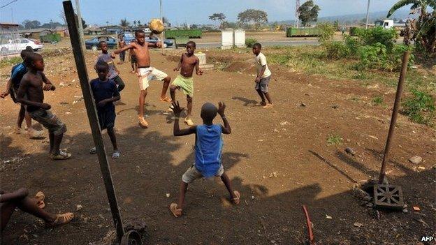 A group of Equatorial Guinea boys play football on 28 January 2012 during a match in an open dry field in Malabo, during the African Cup of Nations