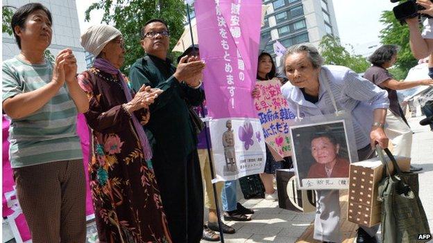 Former 'comfort women' and their relatives gather to stage a standing demonstration near the Diet, or parliament, in Tokyo on 2 June 2014 to demand that Japan formally atone for forcing women into sexual slavery in its wartime military brothels.