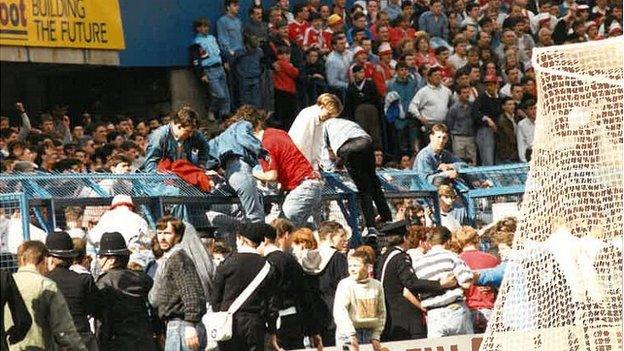 Fans climbing out of the terrace pens