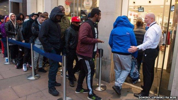 People queue outside a branch of Foot Locker on Oxford Street