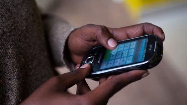 Man in Rwanda using a mobile phone