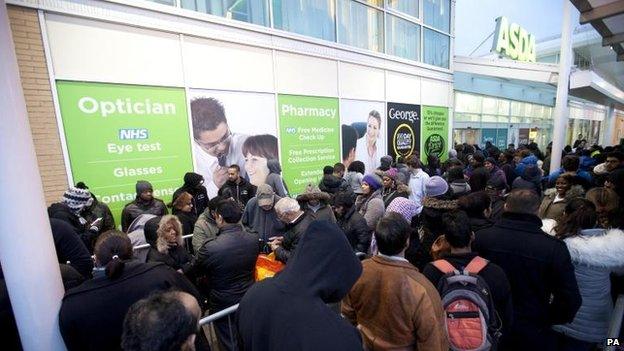 Shoppers queue outside Asda - Black Friday 2014