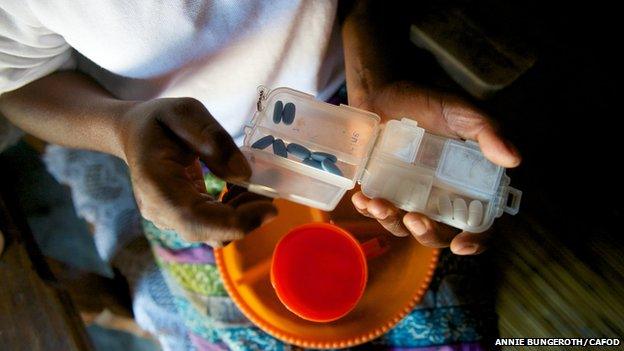 Someone holding ARV mediation in a plastic container