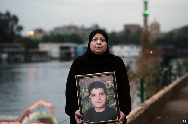 Amal Shaker with a photo of her son Ahmed, killed during the 2011 uprising, in Cairo, 25 November