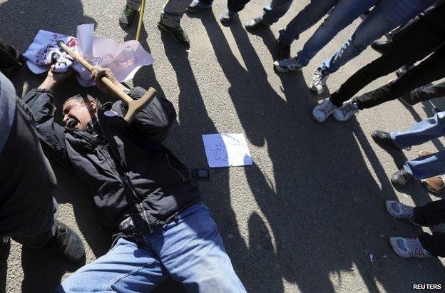 An anti-Mubarak demonstrator reacts to the verdict outside the Cairo court, 29 November