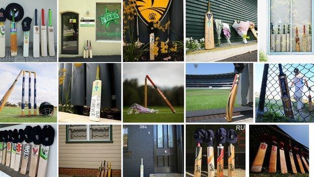 Cricket bats and caps are placed on show as a tribute to Australian cricketer Phillip Hughes.