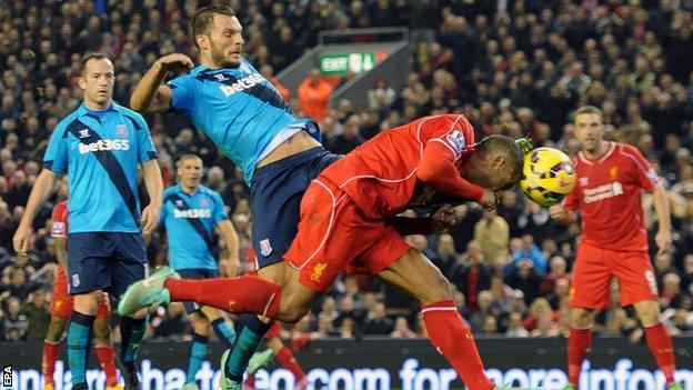 Liverpool defender Glen Johnson (centre) stoops to head in his side's winner against Stoke