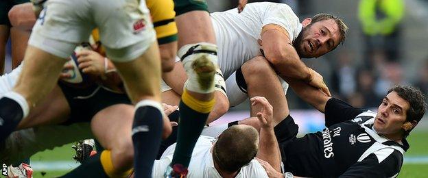 England captain Chris Robshaw inadvertently tackles referee Jerome Garces