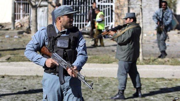 Afghan security forces stand guard at the site of a suicide attack in Kabul, Afghanistan - 16 November 2014