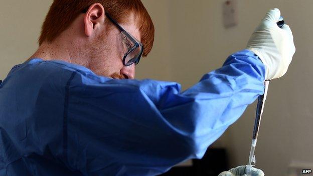 A virologist works in a testing lab in Kerry Town treatment centre, on the outskirts of Freetown (13 November 2014)