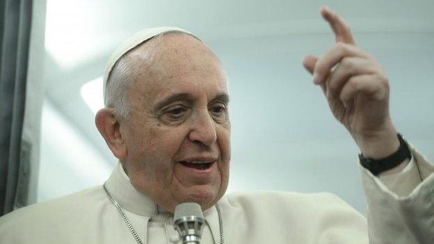 Pope Francis talks with journalists during a press conference aboard the flight towards Rom