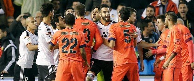 Barcelona and Valencia players clash