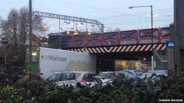 Lorry stuck under bridge