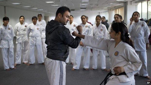 Women from the Delhi police force, undergo martial arts training at an institute in New Delhi, India, Tuesday, Nov. 25, 2014