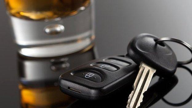 Car keys and glass containing alcohol