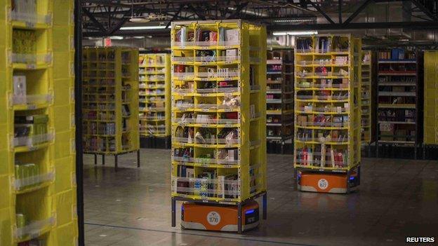 Kiva robots carrying goods in Amazon fulfilment centre