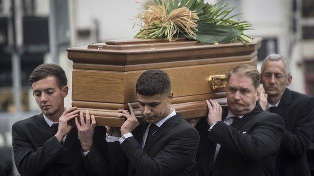 Friends and family carry the coffin of Ben Pocock