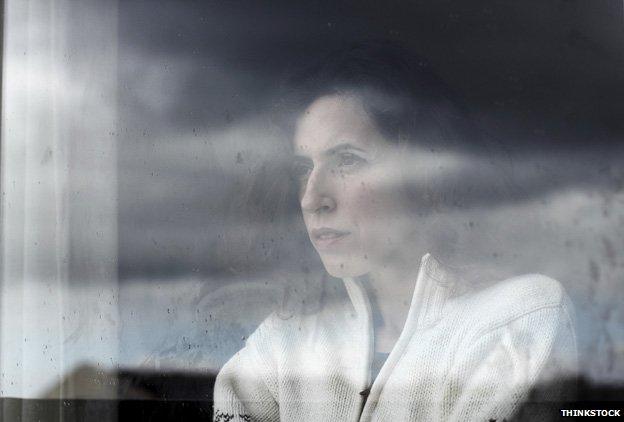 Woman looking out of window