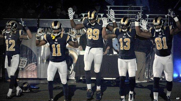 Five NFL players take the field in St Louis with a Ferguson protest gesture.