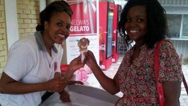 Mercy Kitomari serving a customer buying an ice cream in Dar es Salaam, Tanzania