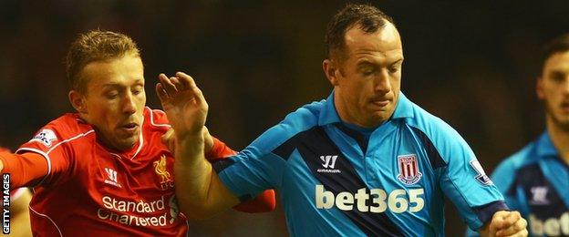 Stoke City midfielder Charlie Adam (right) in action against Liverpool