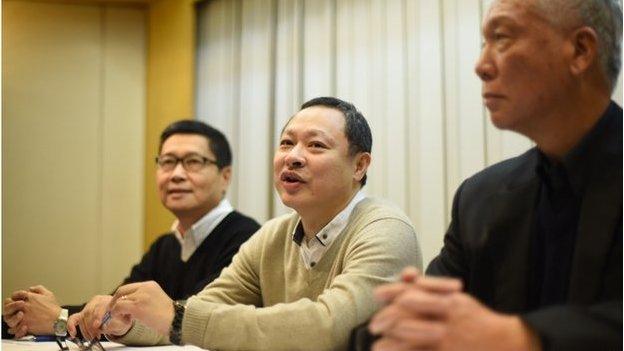 Pro-democracy activists Benny Tai (C) attends a press conference with Chan Kin-man (L) and Chu Yiu-ming (R) in Hong Kong on 2 December 2014.