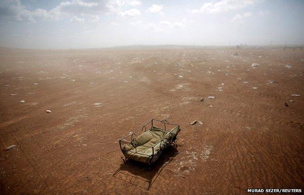 A cradle left behind by Syrian Kurdish refugees lies at the Turkish-Syrian border near Suruc