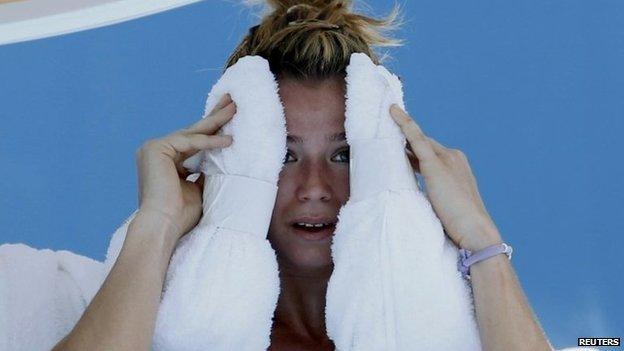 File photo: Camila Giorgi of Italy holds an ice towel to her face during her women's singles match against Alize Cornet of France at the Australian Open 2014 tennis tournament in Melbourne, 16 January 2014