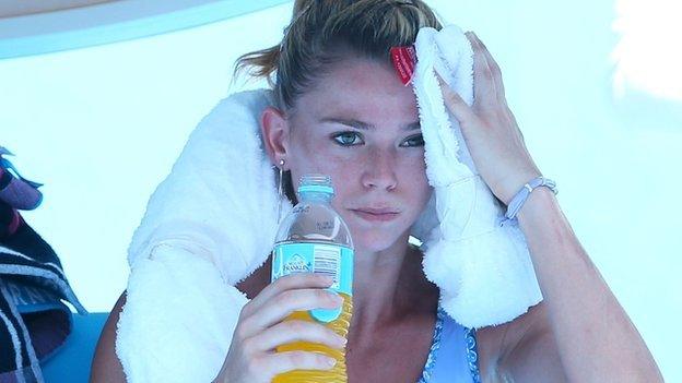 File photo: Camila Giorgi of Italy holds an ice towel to her face during her women's singles match against Alize Cornet of France at the Australian Open 2014 tennis tournament in Melbourne, 16 January 2014