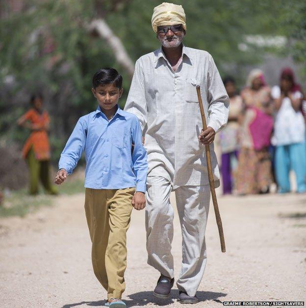 Shangkarlal Bishnoi walking with his grandson