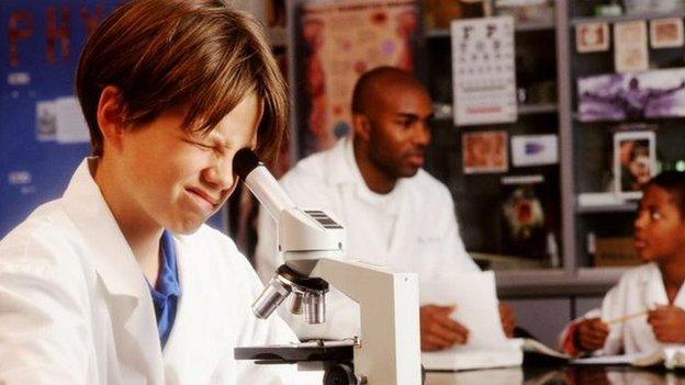 Pupil looking into a microscope