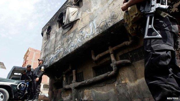 Police officers outside damaged Kerdasa station