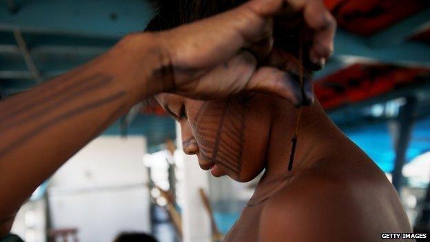 Munduruku boy prepares for protest November 26, 2014 near Sao Luiz do Tapajos, Para State, Brazil