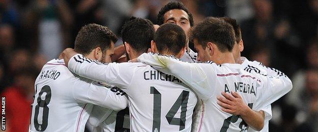 Jese Rodriguez of Real Madrid celebrates with team-mates after scoring against Cornella