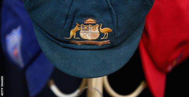 The Baggy Green of Phillip Hughes and his state cricket caps hang on a hat rack at Macksville High School