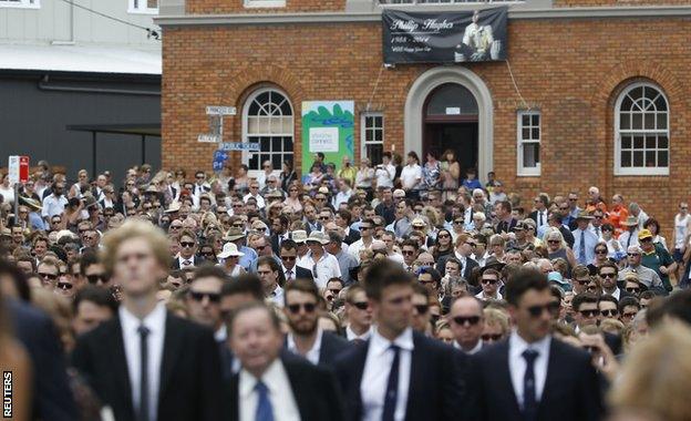 Thousands march through Macksville following the funeral