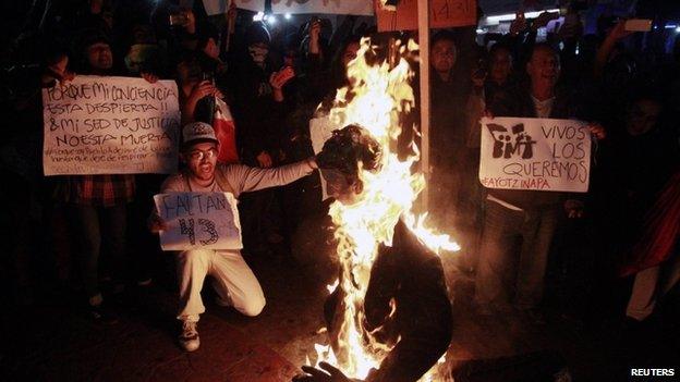 Protestors burn effigy of the president